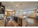 Kitchen island with seating provides a view of the dining and living areas at 11828 Churchfield St, Parker, CO 80134