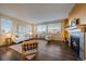 Bright living room with a fireplace, hardwood floors, and comfortable seating at 11828 Churchfield St, Parker, CO 80134