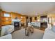 Open-concept living room with a fireplace, dark hardwood floors, and seamless kitchen access at 11828 Churchfield St, Parker, CO 80134