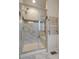 This spa shower features marble tiling and has a built-in shower bench and shelving at 11828 Churchfield St, Parker, CO 80134