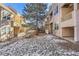 View of building from the back, showing landscaping and snow at 979 S Miller St # 202, Lakewood, CO 80226