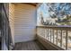 Small balcony with wood deck and view of trees and buildings at 979 S Miller St # 202, Lakewood, CO 80226