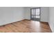 Bedroom with wood-look floors and sliding glass door to balcony at 979 S Miller St # 202, Lakewood, CO 80226