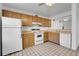 Kitchen with wood cabinets and white appliances at 979 S Miller St # 202, Lakewood, CO 80226