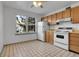 Kitchen with wood cabinets and white appliances at 979 S Miller St # 202, Lakewood, CO 80226