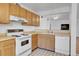 Galley kitchen with wood cabinets and appliances at 979 S Miller St # 202, Lakewood, CO 80226