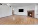 Living room with brick fireplace and wood floors at 979 S Miller St # 202, Lakewood, CO 80226