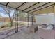 Covered patio featuring a yard, stone foundation, and a shed in the background at 1270 Elmira St, Aurora, CO 80010