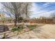 An outdoor view of the backyard with a paved area, some grass, and a wooden fence at 1270 Elmira St, Aurora, CO 80010