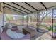 Relaxing covered patio featuring a stone foundation, outdoor furniture set, and a yard at 1270 Elmira St, Aurora, CO 80010