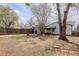 View of the backyard with a mix of sandy ground and sparse grass, along with seating at 1270 Elmira St, Aurora, CO 80010
