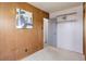 This bedroom offers paneled walls, carpeted floors, built-in shelves, and a door to another room at 1270 Elmira St, Aurora, CO 80010