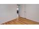 This bedroom features hardwood floors, neutral paint, and open access to another room at 1270 Elmira St, Aurora, CO 80010