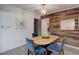Cozy dining area with wood floors, rustic wood wall, and stylish light fixture above the dining table at 1270 Elmira St, Aurora, CO 80010