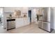 Stainless steel refrigerator in a well-lit kitchen featuring white cabinetry and modern appliances at 1270 Elmira St, Aurora, CO 80010