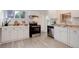Bright kitchen featuring white cabinets, stainless steel appliances, and a window with natural light at 1270 Elmira St, Aurora, CO 80010