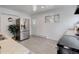 Well-lit kitchen featuring stainless steel refrigerator and appliances with sleek, white cabinets at 1270 Elmira St, Aurora, CO 80010
