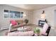 Comfortable living room featuring a cozy couch, stylish chairs, and wood flooring at 1270 Elmira St, Aurora, CO 80010