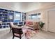 Cozy living room with a large window, built-in shelving, and comfortable seating arrangement on top of an area rug at 1270 Elmira St, Aurora, CO 80010