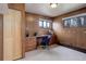 Home office space features wood paneled walls, carpeted floors, built-in desk, and ample lighting at 1270 Elmira St, Aurora, CO 80010