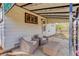 Cozy patio area with an outdoor sitting set, metal awning, and access to the home at 1270 Elmira St, Aurora, CO 80010