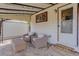 Outdoor covered patio featuring stone foundation, outdoor furniture set, yard, and access to shed at 1270 Elmira St, Aurora, CO 80010