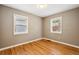 Neutral bedroom featuring hardwood floors, fresh paint and two windows allowing for ample natural light at 116 N Gilbert St, Castle Rock, CO 80104
