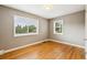Bright bedroom with hardwood floors and two windows offering lots of natural light and tree views at 116 N Gilbert St, Castle Rock, CO 80104