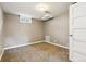 Well-lit bedroom with neutral walls, plush carpet, and a window providing natural light at 116 N Gilbert St, Castle Rock, CO 80104