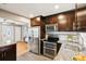 Updated kitchen with stainless steel appliances, granite countertops, dark cabinetry and an attached dining area at 116 N Gilbert St, Castle Rock, CO 80104