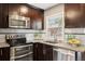 Updated kitchen featuring granite countertops, stainless steel appliances and undermount sink with white subway tile backsplash at 116 N Gilbert St, Castle Rock, CO 80104