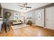Bright living room featuring hardwood floors, large windows, and a welcoming entryway with a stylish white door at 116 N Gilbert St, Castle Rock, CO 80104