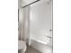 Bathroom with a tub and shower featuring white subway tiles at 1810 Irving St # 8, Denver, CO 80204