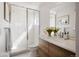 Bathroom featuring a shower with glass door, wood vanity, and lots of natural light at 1810 Irving St # 8, Denver, CO 80204