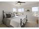 Bright bedroom featuring a black metal bed frame, ceiling fan and plenty of natural light from multiple windows at 1810 Irving St # 8, Denver, CO 80204