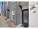 Modern townhome with contemporary gray siding and a stylish black front door with keypad entry at 1810 Irving St # 8, Denver, CO 80204