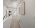 Hallway featuring a stacked washer and dryer, leading to a naturally lit room at 1810 Irving St # 8, Denver, CO 80204