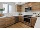 Contemporary kitchen featuring stainless steel appliances, light countertops, and modern wooden cabinetry at 1810 Irving St # 8, Denver, CO 80204
