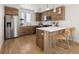 Modern kitchen featuring stainless steel appliances, light countertops, and a center island with bar seating at 1810 Irving St # 8, Denver, CO 80204