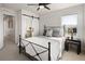 Bright bedroom features a ceiling fan, a window, and a bathroom with a sliding barn door at 1810 Irving St # 8, Denver, CO 80204