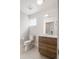 Modern powder room with wood vanity, white countertop, stylish fixtures, and contemporary design at 1810 Irving St # 8, Denver, CO 80204