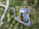 Overhead shot showcases a modern home nestled among mature trees, featuring unique architectural design and beautiful landscaping at 1298 Meadow View Dr, Evergreen, CO 80439