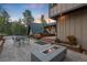 Beautiful backyard patio with landscaping and a fire pit at 1298 Meadow View Dr, Evergreen, CO 80439