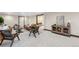 Spacious basement lounge area boasts contemporary decor, plush carpet, and ample seating at 1298 Meadow View Dr, Evergreen, CO 80439