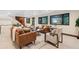 Expansive basement living room with natural light, cozy seating, and access to the outdoors at 1298 Meadow View Dr, Evergreen, CO 80439