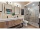 Modern bathroom with double vanity, decorative mirrors, and an enclosed shower at 1298 Meadow View Dr, Evergreen, CO 80439