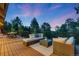 Relaxing outdoor deck area with comfortable seating and stunning forest views at 1298 Meadow View Dr, Evergreen, CO 80439