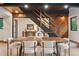 Dining room with wood table, modern chairs, and a stairway that features both wood and wrought iron at 1298 Meadow View Dr, Evergreen, CO 80439