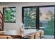Dining room featuring modern table with mountain view through large sliding doors at 1298 Meadow View Dr, Evergreen, CO 80439
