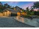 Beautiful modern home with a two-car garage, driveway, and manicured landscaping at 1298 Meadow View Dr, Evergreen, CO 80439